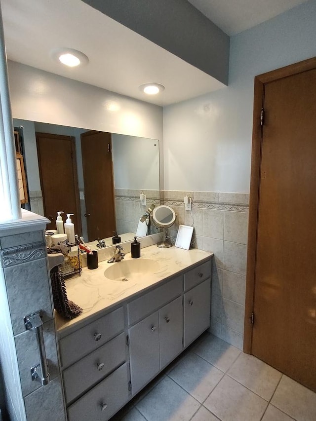 205 Beacon Dr, Belvidere, IL 61008 - bathroom with tile patterned flooring, vanity, tile walls, and a wainscoted wall
