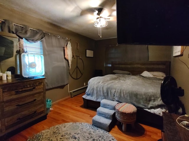 205 Beacon Dr, Belvidere, IL 61008 - bedroom with a baseboard radiator, light wood-style floors, and a ceiling fan