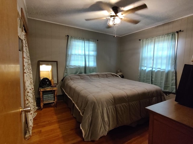 205 Beacon Dr, Belvidere, IL 61008 - bedroom with wood finished floors, crown molding, ceiling fan, and wooden walls