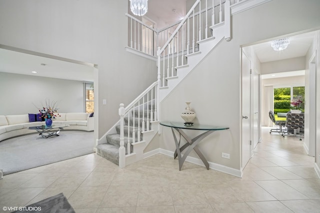4045 N Harvard Ave, Arlington Heights, IL 60004 - stairway with a chandelier, tile patterned floors, a towering ceiling, and baseboards