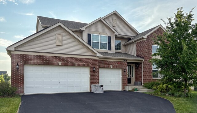 1878 Roseland Ln, Hoffman Estates, IL 60192 - traditional-style home featuring brick siding, asphalt driveway, a garage, and roof with shingles