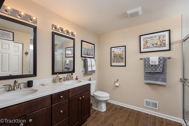 1878 Roseland Ln, Hoffman Estates, IL 60192 - bathroom with double vanity, wood finish floors, and a shower with door