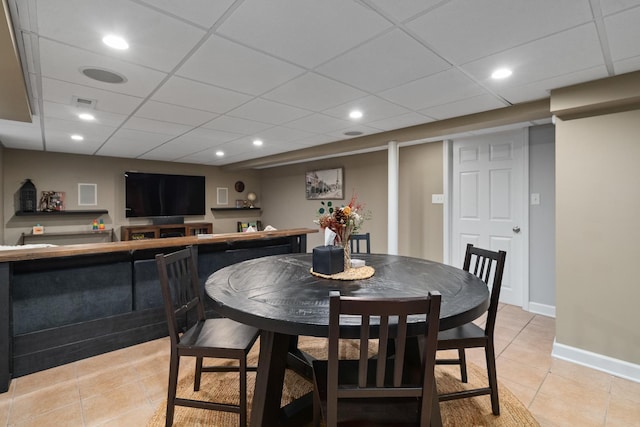 592 E 13th St, Lockport, IL 60441 - dining area with light tile patterned floors, a paneled ceiling, a bar, and recessed lighting