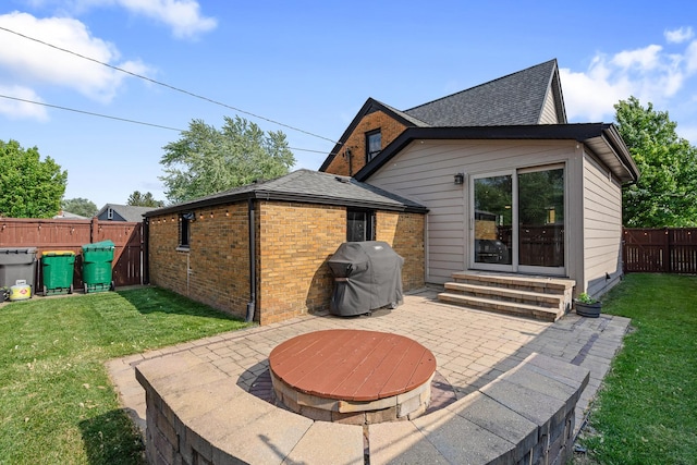 592 E 13th St, Lockport, IL 60441 - rear view of property featuring entry steps, a patio area, brick siding, a fenced backyard, and roof with shingles