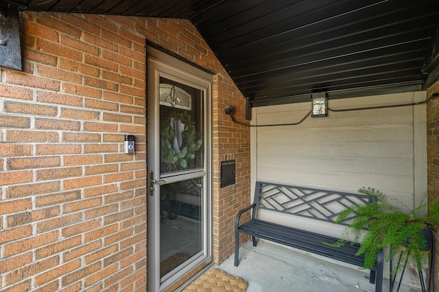 592 E 13th St, Lockport, IL 60441 - doorway to property with a porch and brick siding