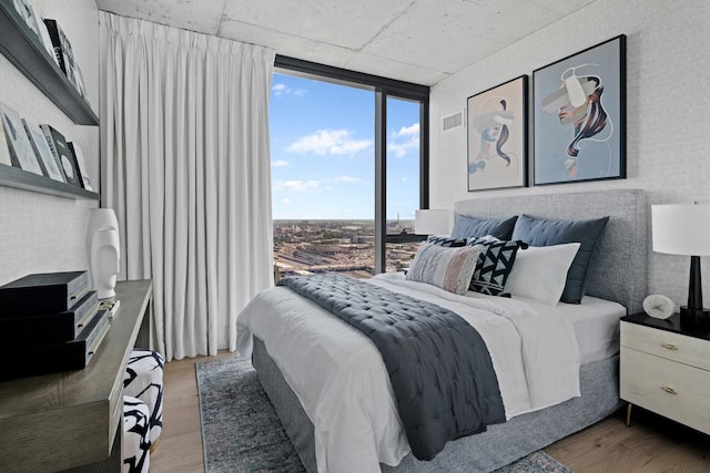 234 W Polk St Unit 3209, Chicago, IL 60607 - bedroom with a wall of windows and light wood-style flooring