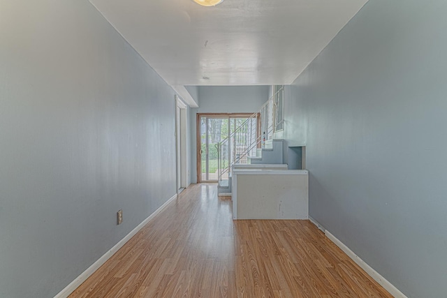 1006 Tacoma St, Carpentersville, IL 60110 - unfurnished living room featuring wood finished floors, stairway, and baseboards