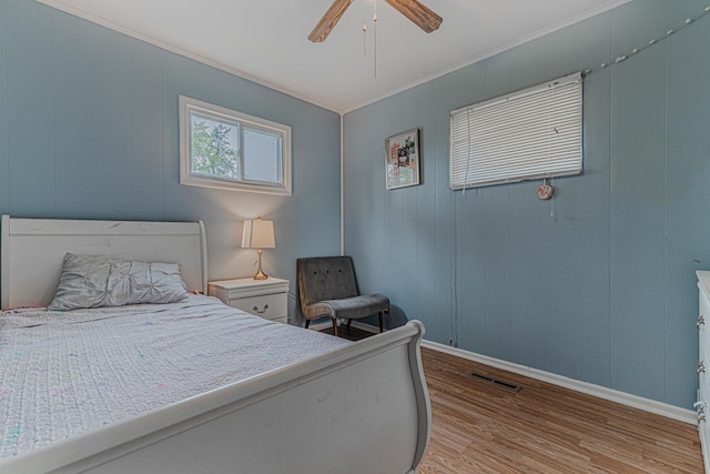 1006 Tacoma St, Carpentersville, IL 60110 - bedroom with light wood-type flooring, baseboards, ornamental molding, and a ceiling fan