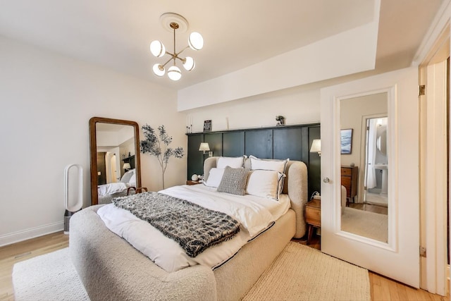 606 W Aldine Ave Unit 3E, Chicago, IL 60657 - bedroom featuring light wood-style flooring and a chandelier