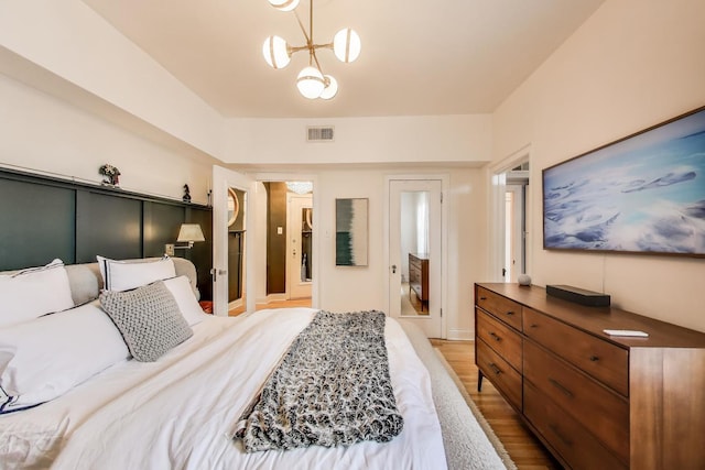 606 W Aldine Ave Unit 3E, Chicago, IL 60657 - bedroom featuring light wood finished floors and a chandelier