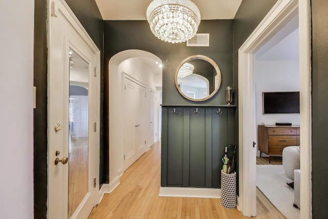 606 W Aldine Ave Unit 3E, Chicago, IL 60657 - hallway featuring light wood finished floors and a chandelier