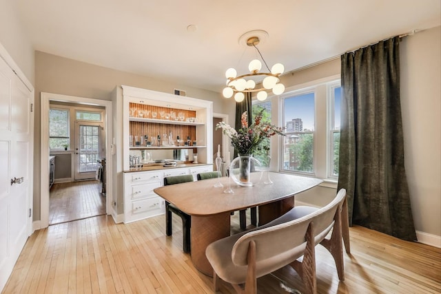 606 W Aldine Ave Unit 3E, Chicago, IL 60657 - dining area featuring light wood-type flooring and a chandelier