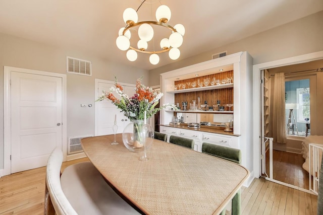 606 W Aldine Ave Unit 3E, Chicago, IL 60657 - dining area featuring a chandelier and light wood-style floors