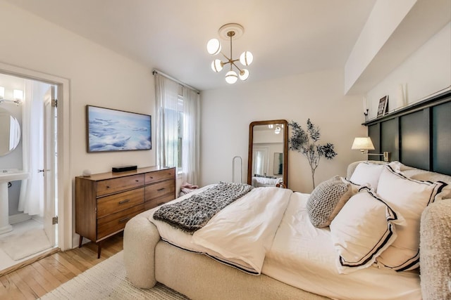 606 W Aldine Ave Unit 3E, Chicago, IL 60657 - bedroom with light wood finished floors and a chandelier