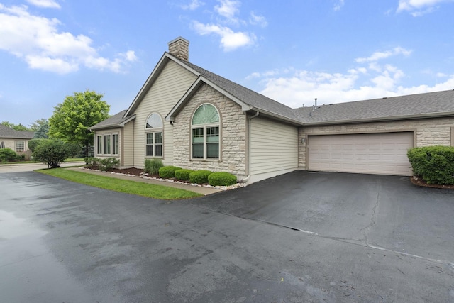1908 Timbers Edge Cir, Joliet, IL 60431 - single story home with stone siding, driveway, a chimney, an attached garage, and a shingled roof