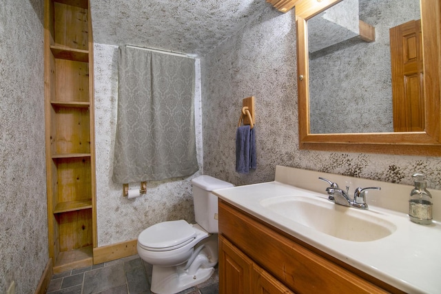 211 N Maple St, Grant Park, IL 60940 - bathroom featuring vanity, toilet, baseboards, and stone finish flooring