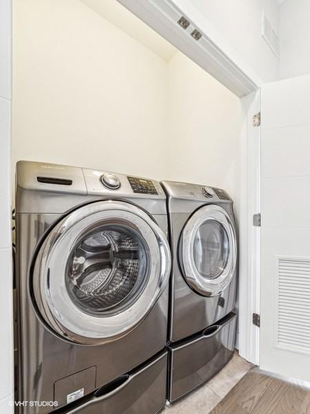 1802 N Mozart St, Chicago, IL 60647 - laundry area with separate washer and dryer and light wood-type flooring