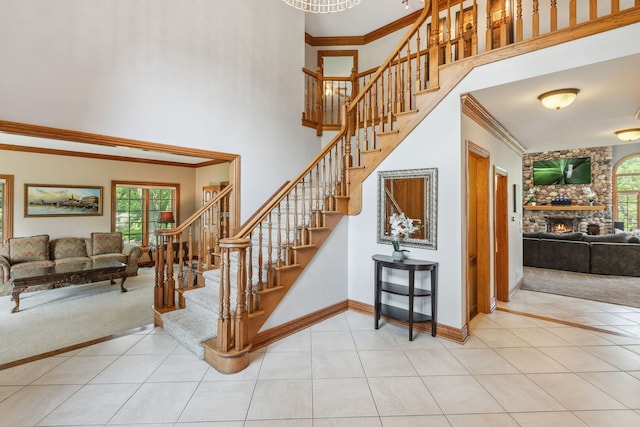 2188 Inverray Rd, Inverness, IL 60067 - stairway featuring a high ceiling, a fireplace, crown molding, tile patterned floors, and carpet