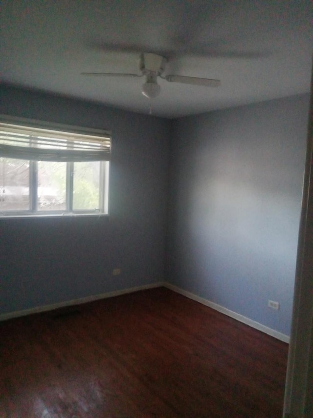 310 New Salem St, Park Forest, IL 60466 - spare room featuring dark wood-type flooring, a ceiling fan, and baseboards