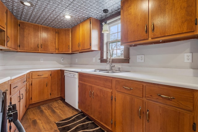 201 S 1st St, Tolono, IL 61880 - kitchen with dishwasher, an ornate ceiling, a sink, wood finished floors, and brown cabinetry