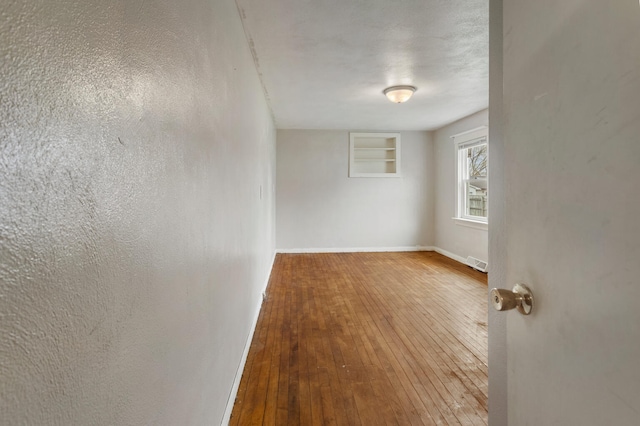201 S 1st St, Tolono, IL 61880 - unfurnished room featuring wood-type flooring and baseboards