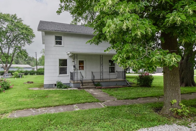 417 E Vermillion St, Odell, IL 60460 - view of front of house featuring covered porch, a front yard, and a shingled roof