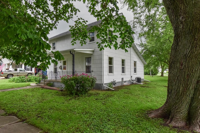 417 E Vermillion St, Odell, IL 60460 - view of front of house with covered porch, a front lawn, and cooling unit