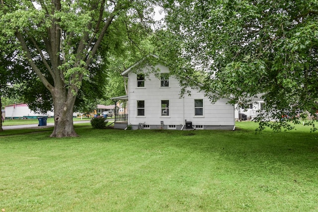 417 E Vermillion St, Odell, IL 60460 - rear view of house with a lawn and central AC unit