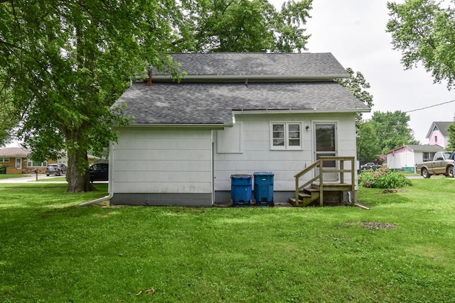 417 E Vermillion St, Odell, IL 60460 - back of property with a shingled roof, a lawn, and entry steps