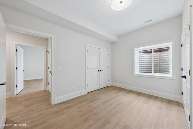 5906 Juniper Ct, Western Springs, IL 60558 - unfurnished bedroom with light wood-style floors, baseboards, and a closet