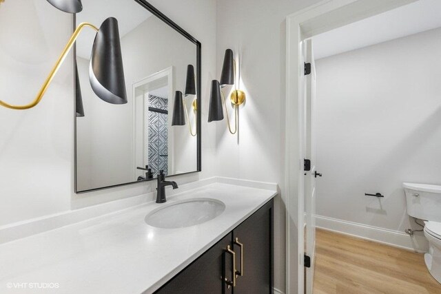 5906 Juniper Ct, Western Springs, IL 60558 - bathroom featuring toilet, vanity, wood finished floors, and baseboards