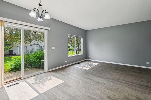3736 Munson St, Plano, IL 60545 - unfurnished room featuring a chandelier and wood finished floors