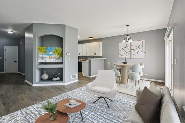 3736 Munson St, Plano, IL 60545 - living area featuring wood finished floors and a chandelier