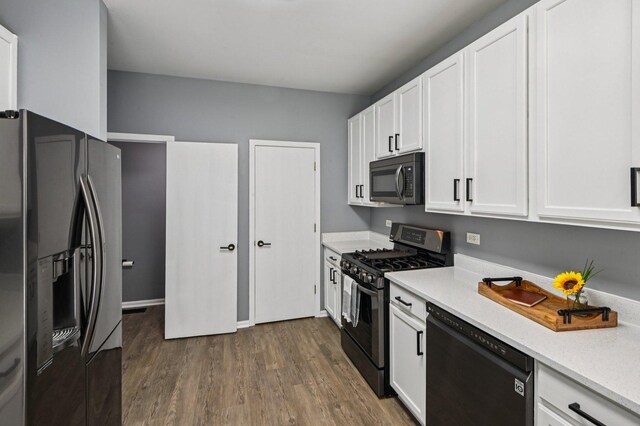 3736 Munson St, Plano, IL 60545 - kitchen featuring black appliances, white cabinets, dark wood finished floors, and light stone countertops