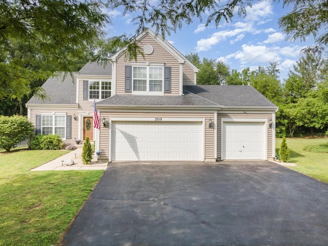 2519 Quail Cv, Carpentersville, IL 60110 - traditional-style home featuring asphalt driveway, a front lawn, and roof with shingles