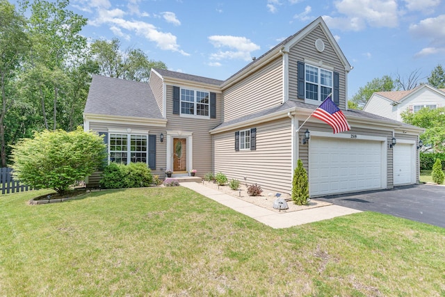 2519 Quail Cv, Carpentersville, IL 60110 - traditional-style house with asphalt driveway, a front lawn, and a garage