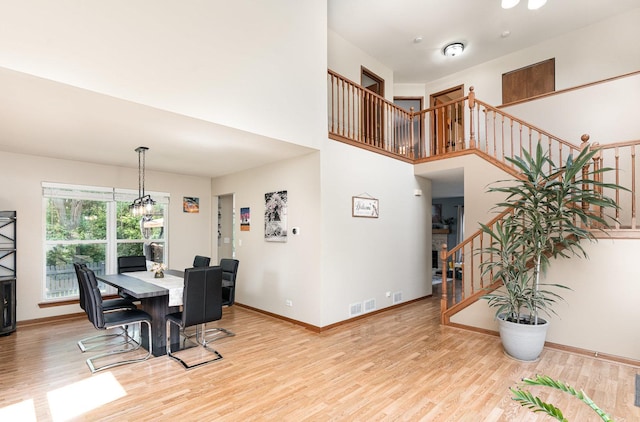 2519 Quail Cv, Carpentersville, IL 60110 - dining room with stairway, wood finished floors, and a towering ceiling