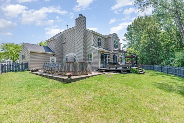 2519 Quail Cv, Carpentersville, IL 60110 - back of property featuring a deck, a fenced backyard, a chimney, and a gazebo