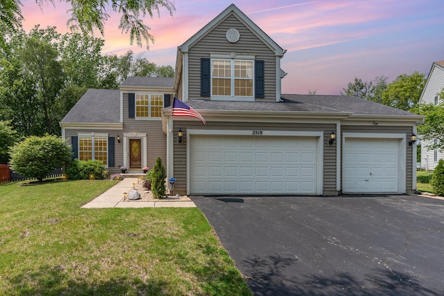 2519 Quail Cv, Carpentersville, IL 60110 - traditional home featuring asphalt driveway and a yard
