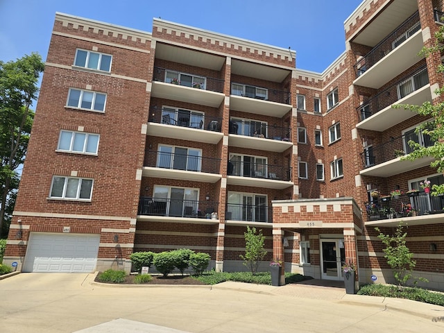 455 W Front St Unit 307, Wheaton, IL 60187 - view of apartment building / complex with a garage and concrete driveway
