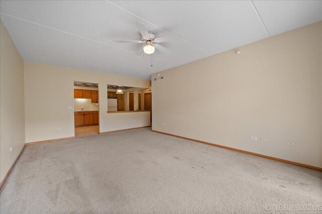 455 W Front St Unit 307, Wheaton, IL 60187 - unfurnished living room featuring a ceiling fan and light carpet