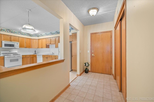 455 W Front St Unit 307, Wheaton, IL 60187 - kitchen with white appliances, light countertops, a textured ceiling, hanging light fixtures, and light tile patterned flooring