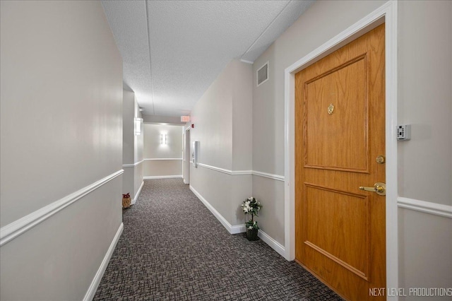 455 W Front St Unit 307, Wheaton, IL 60187 - hallway featuring dark carpet and a textured ceiling