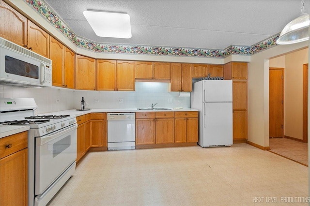 455 W Front St Unit 307, Wheaton, IL 60187 - kitchen featuring white appliances, light countertops, brown cabinetry, backsplash, and light flooring