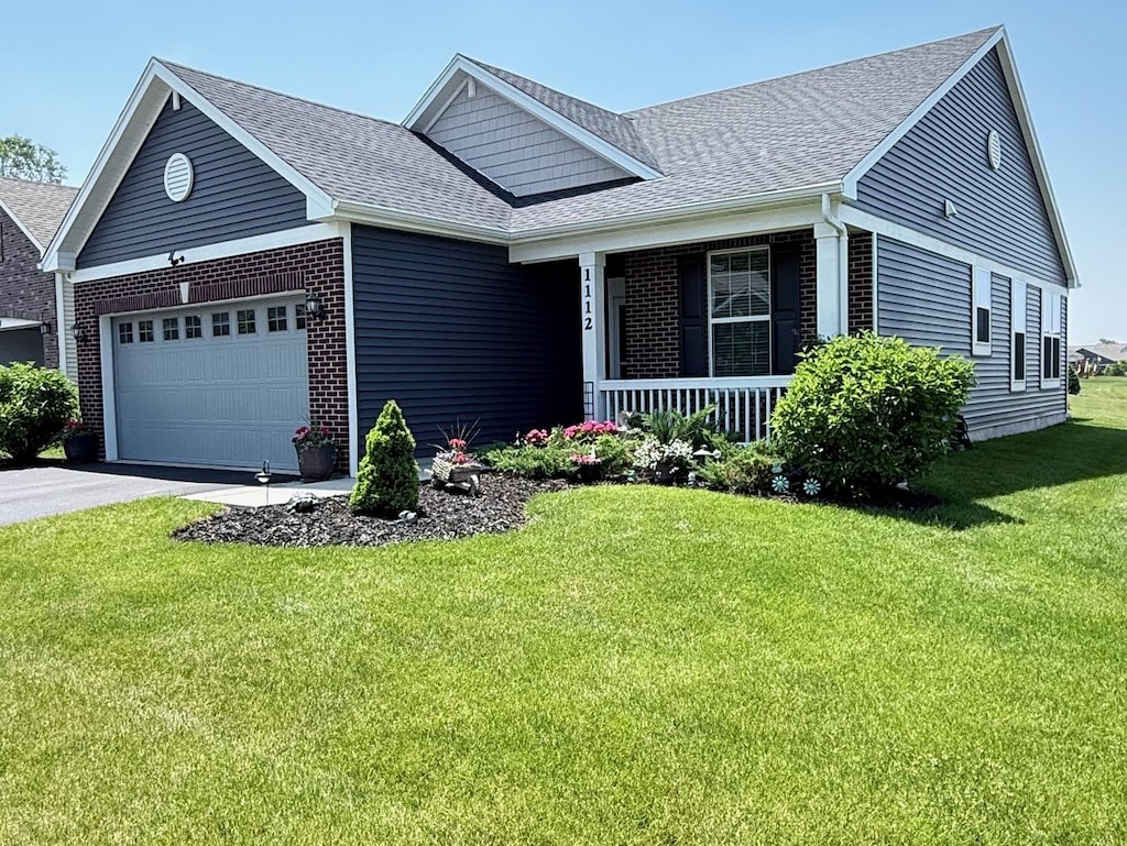 1112 Black Cherry Dr, Crystal Lake, IL 60012 - view of front facade featuring covered porch, an attached garage, brick siding, and a shingled roof