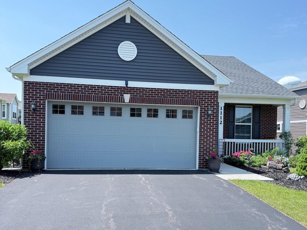 1112 Black Cherry Dr, Crystal Lake, IL 60012 - single story home featuring brick siding, asphalt driveway, a porch, and a garage