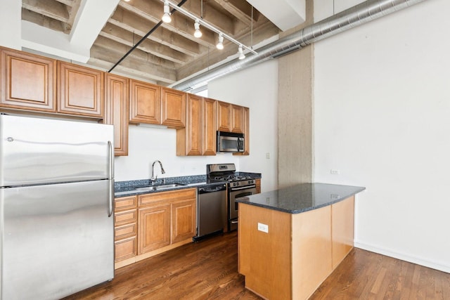 1645 W Ogden Ave Unit 516, Chicago, IL 60612 - kitchen featuring stainless steel appliances, a sink, dark wood-style flooring, a peninsula, and dark stone counters