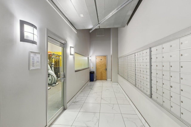 1645 W Ogden Ave Unit 516, Chicago, IL 60612 - hall featuring mail area and marble look tile flooring