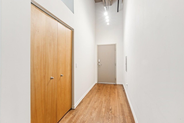 1645 W Ogden Ave Unit 516, Chicago, IL 60612 - corridor featuring a high ceiling, light wood-style flooring, and baseboards