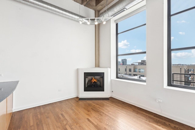 1645 W Ogden Ave Unit 516, Chicago, IL 60612 - unfurnished living room featuring wood finished floors and baseboards
